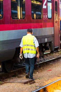 Train crew man doing checkings on the platform at the Bucharest North Railway Station in Bucharest, Romania, 2020