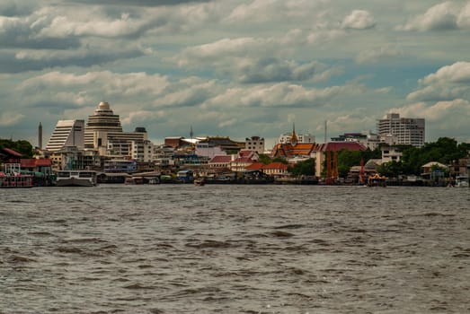 Bangkok, Thailand - 21 Jul 2019 : A view of the bank of Bangkok's Chao Phraya River showing the several tall buildings in the beautiful skyline.