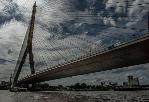 Bangkok, thailand 21 Jul, 2019 : Rama Rama VIII bridge, Rope Bridge across the Chao Phraya River, A tall V-shape pylon tower with view blue sky is background and Cityscape of Bangkok.