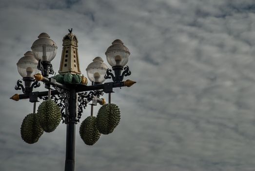 Nonthaburi, Thailand - 21 Jul 2019 : Street lamp in front of the Chinese shrine decorated with durian balls and has a background of blue sky and white clouds. Space for messages.
