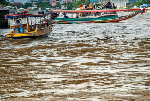 Bangkok, Thailand - 21 Jul 2019 : 2 passenger ferryboat on the Chao Phraya River.