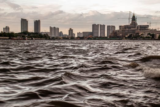 Bangkok, Thailand - 21 Jul 2019 : A view of the bank of Bangkok's Chao Phraya River showing the several tall buildings in the beautiful sky.