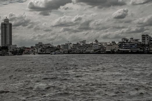 Bangkok, Thailand - 21 Jul 2019 : A view of the bank of Bangkok's Chao Phraya River showing the several tall buildings in the beautiful skyline.