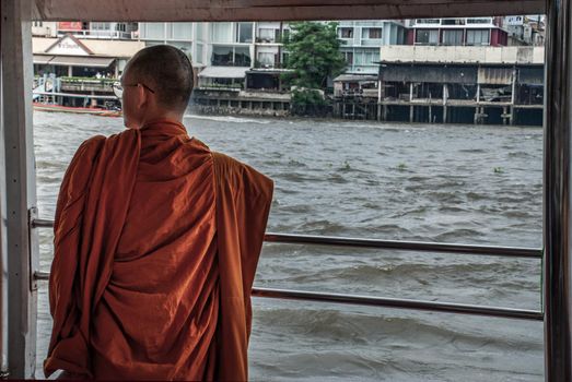 Bangkok, thailand 21 Jul, 2019 : The monks stood on the Chao Phraya Express Boat to travel by water to the temple.
