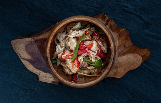 Thai Spicy food, Spicy stir fried fish balls and thai herbs vegetables in wooden bowl : in Thai language called "Pad Cha " Top view.