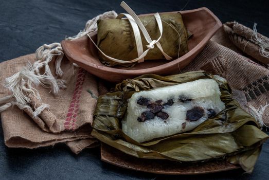 Khao tom mat, a Laotian and Thai dessert of seasoned steamed sticky rice wrapped in banana leaves normally inserted with filling made of banana and black beans for special occasions or merit making, Steamed mung bean with sticky rice.