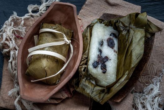 Khao tom mat, a Laotian and Thai dessert of seasoned steamed sticky rice wrapped in banana leaves normally inserted with filling made of banana and black beans for special occasions or merit making, Steamed mung bean with sticky rice.