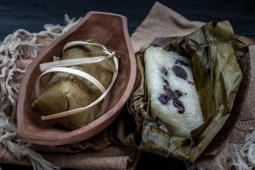 Khao tom mat, a Laotian and Thai dessert of seasoned steamed sticky rice wrapped in banana leaves normally inserted with filling made of banana and black beans for special occasions or merit making, Steamed mung bean with sticky rice.