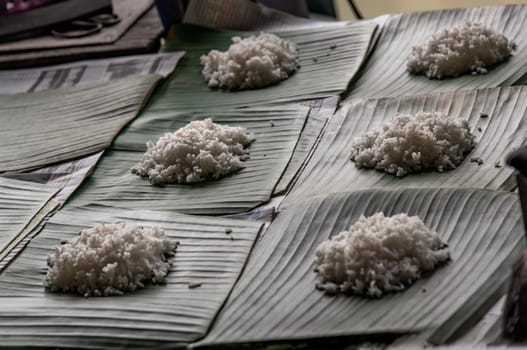 White rice is cooked rice by steaming or boiling on served on a banana leaf in Thai restaurant that is staple food in Thailand, Selective focus.