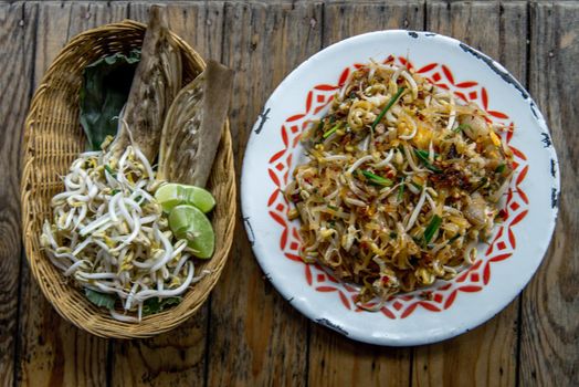 Popular Thai fried local Korat noodle with cube tofu and shrimp, call Pad Mee Korat, Korat Stir fried Rice Noodle, Mee Korat is the name of the local region in Thailand, Selective focus.
