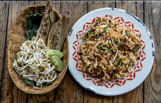 Popular Thai fried local Korat noodle with cube tofu and shrimp, call Pad Mee Korat, Korat Stir fried Rice Noodle, Mee Korat is the name of the local region in Thailand, Selective focus.