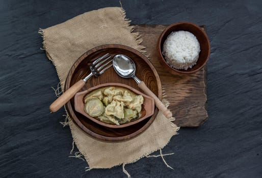Kaeng kheow hwan is green curry with fish ball served with steamed rice. Popular traditional food of Thailand. look delicious. Top view, Selective focus.