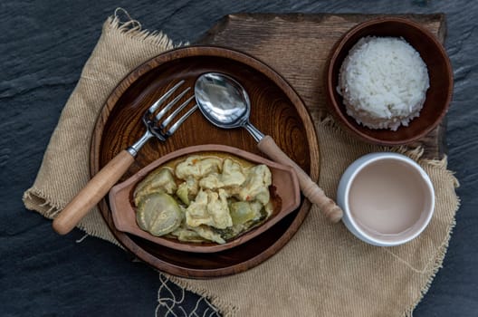 Kaeng kheow hwan is green curry with fish ball served with steamed rice. Popular traditional food of Thailand. look delicious. Top view, Selective focus.