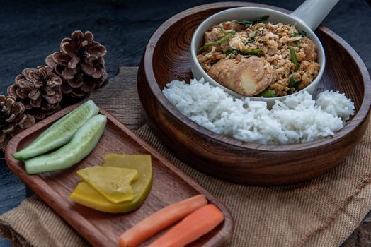 Thai food, Stir fried egg tofu with spring onion with Herbs vegetables served with steamed rice in wooden bowl, Oblique view from the top.