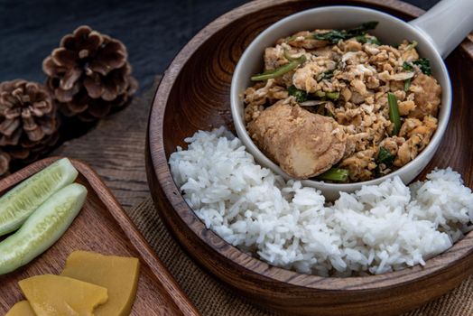 Thai food, Stir fried egg tofu with spring onion with Herbs vegetables served with steamed rice in wooden bowl, Oblique view from the top.