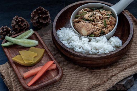 Thai food, Stir fried egg tofu with spring onion with Herbs vegetables served with steamed rice in wooden bowl, Oblique view from the top.