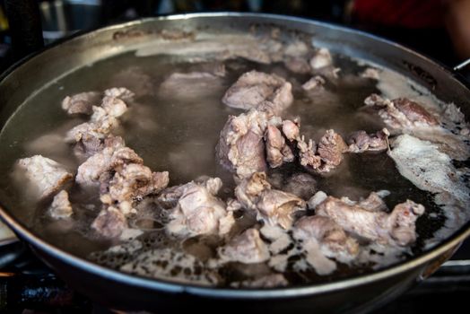 Boiling pork rip soup in hot in pot boiling water, Soup of pork rips, Selective focus.