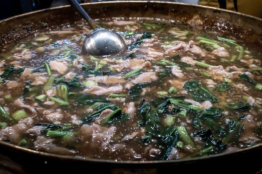 Fried noodle with pork and broccoli in pot, full pot, Selective focus.
