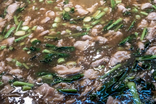 Close-up of Fried noodle with pork and broccoli in pot, full pot, Selective focus.