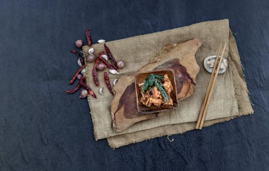 Thai Spicy food, Spicy Stir Fried Deep Fish Fillet with Herbs vegetables  in wooden bowl : in Thai language called "Pad Cha ". Top view. copy space, Selective focus.