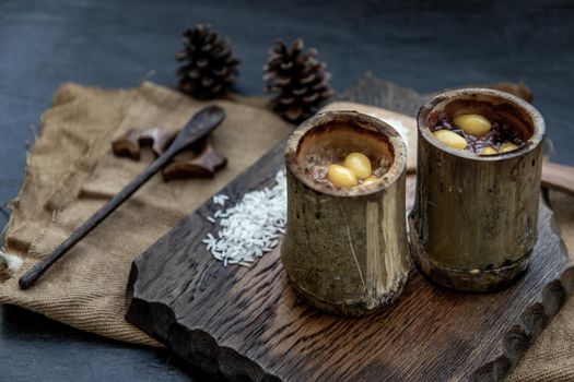 Sticky Rice Cooked with Coconut milk (Khao lam) or Glutinous rice roasted in bamboo joints on wooden, Thai dessert concept, Oblique view from the top.