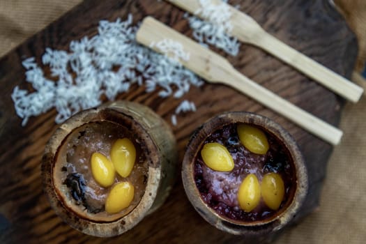 Sticky Rice Cooked with Coconut milk (Khao lam) or Glutinous rice roasted in bamboo joints on wooden, Thai dessert concept, Top view.