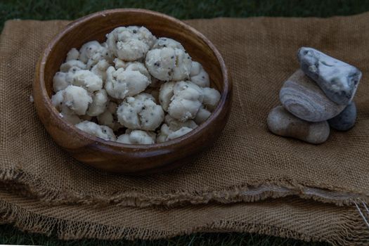 Thai Shortbread Cookies (Thai Dessert), Kanom Kleeb Lum Duen on burlap fabric background, Oblique view from the top, Selective focus.