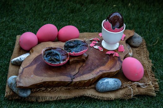 Asian Traditional Food, Pink Century eggs (Pidan Eggs) also known as preserved egg, hundred-year egg, thousand-year egg are a Chinese preserved food product and delicacy made by preserving duck, chicken in A Mixture of Ash, Salt, Red Lime, Sodium Carbonate, Tea Leaves and Zinc Oxide, Selective focus.