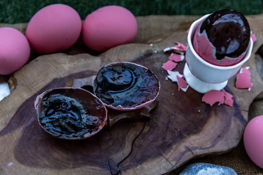 Asian Traditional Food, Pink Century eggs (Pidan Eggs) also known as preserved egg, hundred-year egg, thousand-year egg are a Chinese preserved food product and delicacy made by preserving duck, chicken in A Mixture of Ash, Salt, Red Lime, Sodium Carbonate, Tea Leaves and Zinc Oxide, Selective focus.