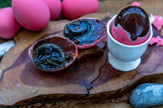 Asian Traditional Food, Pink Century eggs (Pidan Eggs) also known as preserved egg, hundred-year egg, thousand-year egg are a Chinese preserved food product and delicacy made by preserving duck, chicken in A Mixture of Ash, Salt, Red Lime, Sodium Carbonate, Tea Leaves and Zinc Oxide, Selective focus.