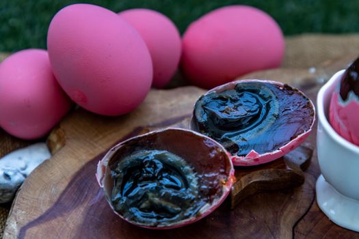 Asian Traditional Food, Pink Century eggs (Pidan Eggs) also known as preserved egg, hundred-year egg, thousand-year egg are a Chinese preserved food product and delicacy made by preserving duck, chicken in A Mixture of Ash, Salt, Red Lime, Sodium Carbonate, Tea Leaves and Zinc Oxide, Selective focus.