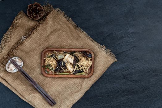 Thai food, Stir-fried tofu with ginger in wooden tray, view from above.