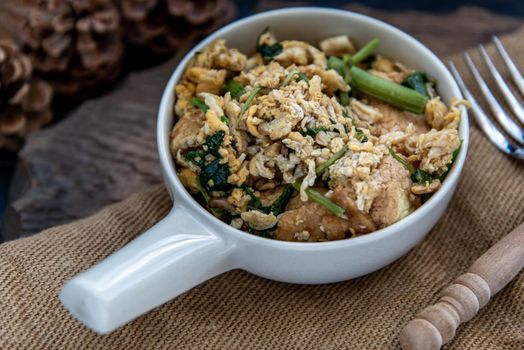 Thai food, Stir fried egg tofu with spring onion in white bowl, Oblique view from the top.
