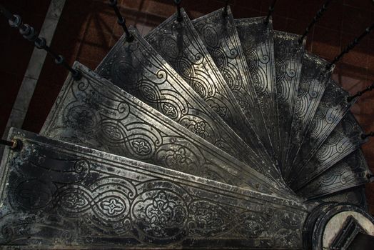 Bangkok, Thailand - Oct 05, 2019 : Upside view of a spiral staircase pattern. Spiral stairs circle in old cozy courtyard architecture. House ladder decoration interior. Architectural element of a historic building. Close-up