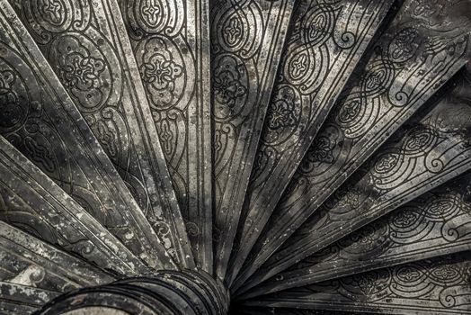 Bangkok, Thailand - Oct 05, 2019 : Upside view of a spiral staircase pattern. Spiral stairs circle in old cozy courtyard architecture. House ladder decoration interior. Architectural element of a historic building. Close-up