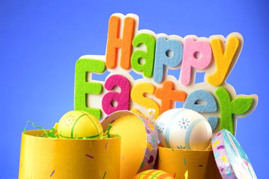 A festive holiday scene with the words saying Happy Easter over a blue background.
