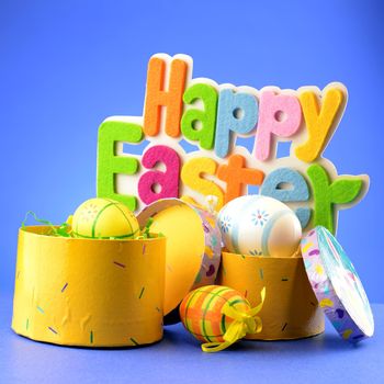 A festive holiday scene with the words saying Happy Easter over a blue background.