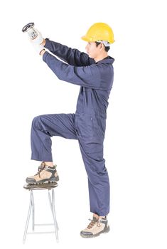 Young handyman in uniform hold grinder, Cutout isolated on white background with clipping path