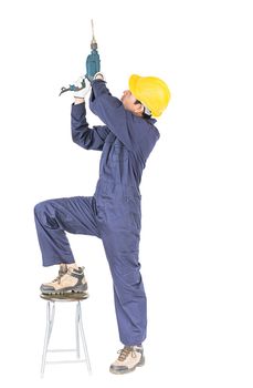 Young handyman in unifrom standing with his electric drill, Cutout isolated on white background with clipping path