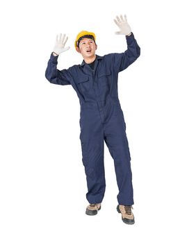 Portrait of a workman with blue coveralls and hardhat in a uniform on white background with clipping path