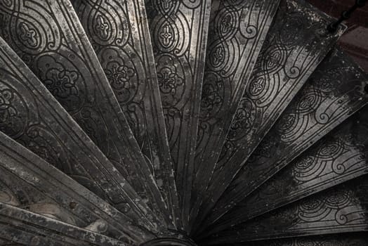 Bangkok, Thailand - Oct 05, 2019 : Upside view of a spiral staircase pattern. Spiral stairs circle in old cozy courtyard architecture. House ladder decoration interior. Architectural element of a historic building. Close-up