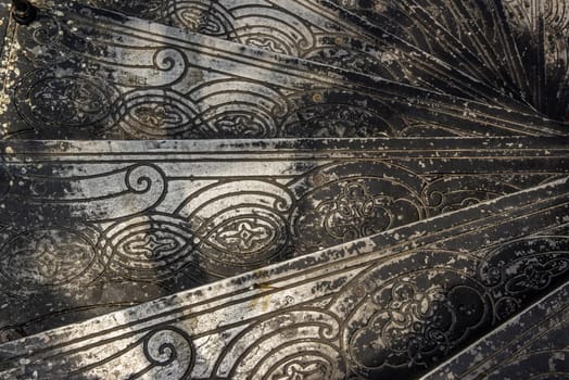 Bangkok, Thailand - Oct 05, 2019 : Upside view of a spiral staircase pattern. Spiral stairs circle in old cozy courtyard architecture. House ladder decoration interior. Architectural element of a historic building. Close-up
