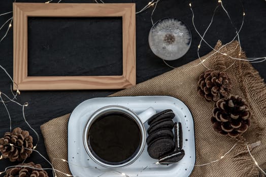 Cup of coffee with chocolate chip cookies on wooden tray. Concept for a tasty snack, Selective focus, Top view.