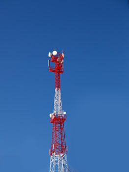 Cellular base station against blue sky on sunny day.