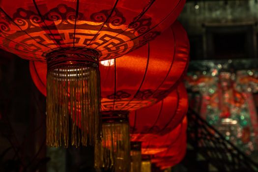Chinese lantern & light bulb on dark background. The interior asian decorations. Selective focus.