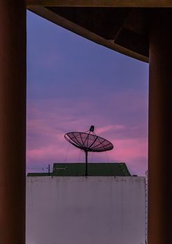 Black Satellite Dish Antenna Receiver Against on Blue Sky background  for Communication and Media Industry, Symbolizing Global Communications. Selective focus.