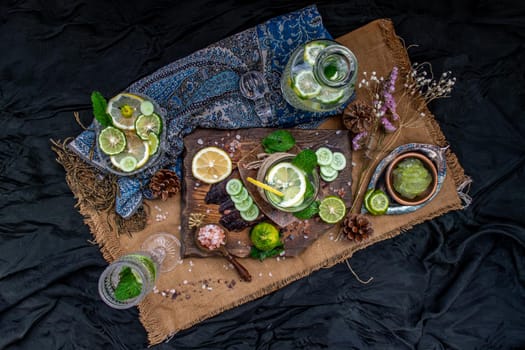 Cold water with lemon, kaffir lime, cucumber and mint leave on wooden background. Summer time, Healthy drink, vegetable juice, healthy food concept, Selective Focus.