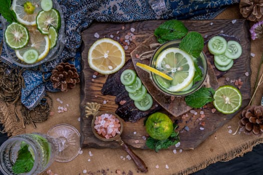 Cold water with lemon, kaffir lime, cucumber and mint leave on wooden background. Summer time, Healthy drink, vegetable juice, healthy food concept, Selective Focus.