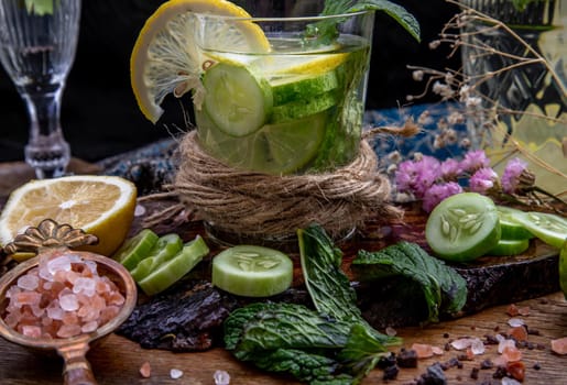 Cold water with lemon, kaffir lime, cucumber and mint leave on wooden background. Summer time, Healthy drink, vegetable juice, healthy food concept, Selective Focus.