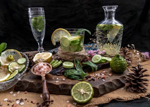 Cold water with lemon, kaffir lime, cucumber and mint leave on wooden background. Summer time, Healthy drink, vegetable juice, healthy food concept, Selective Focus.